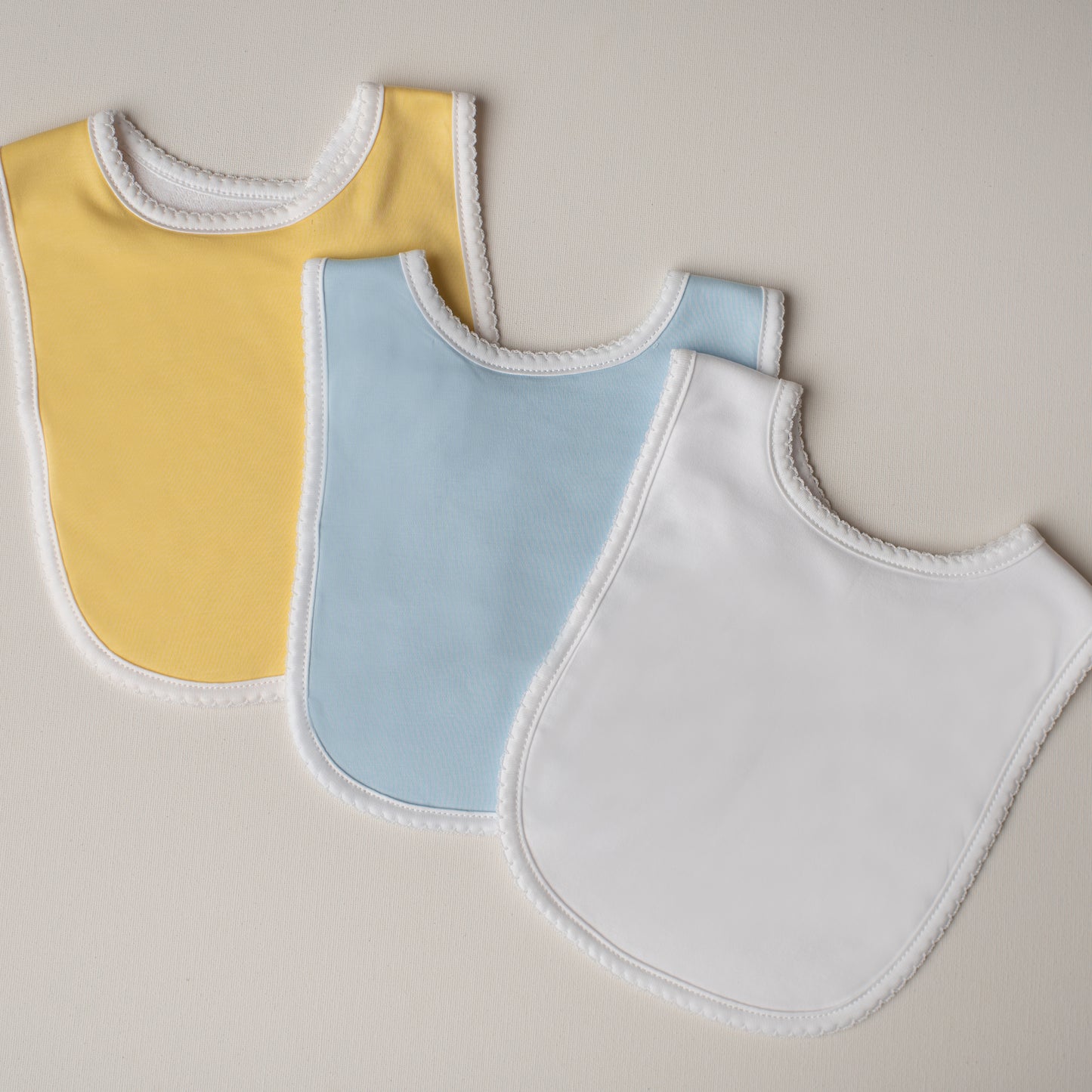 Kit: 3 Babadores Tucano Pima Atoalhado - Azul, Branco e Amarelo